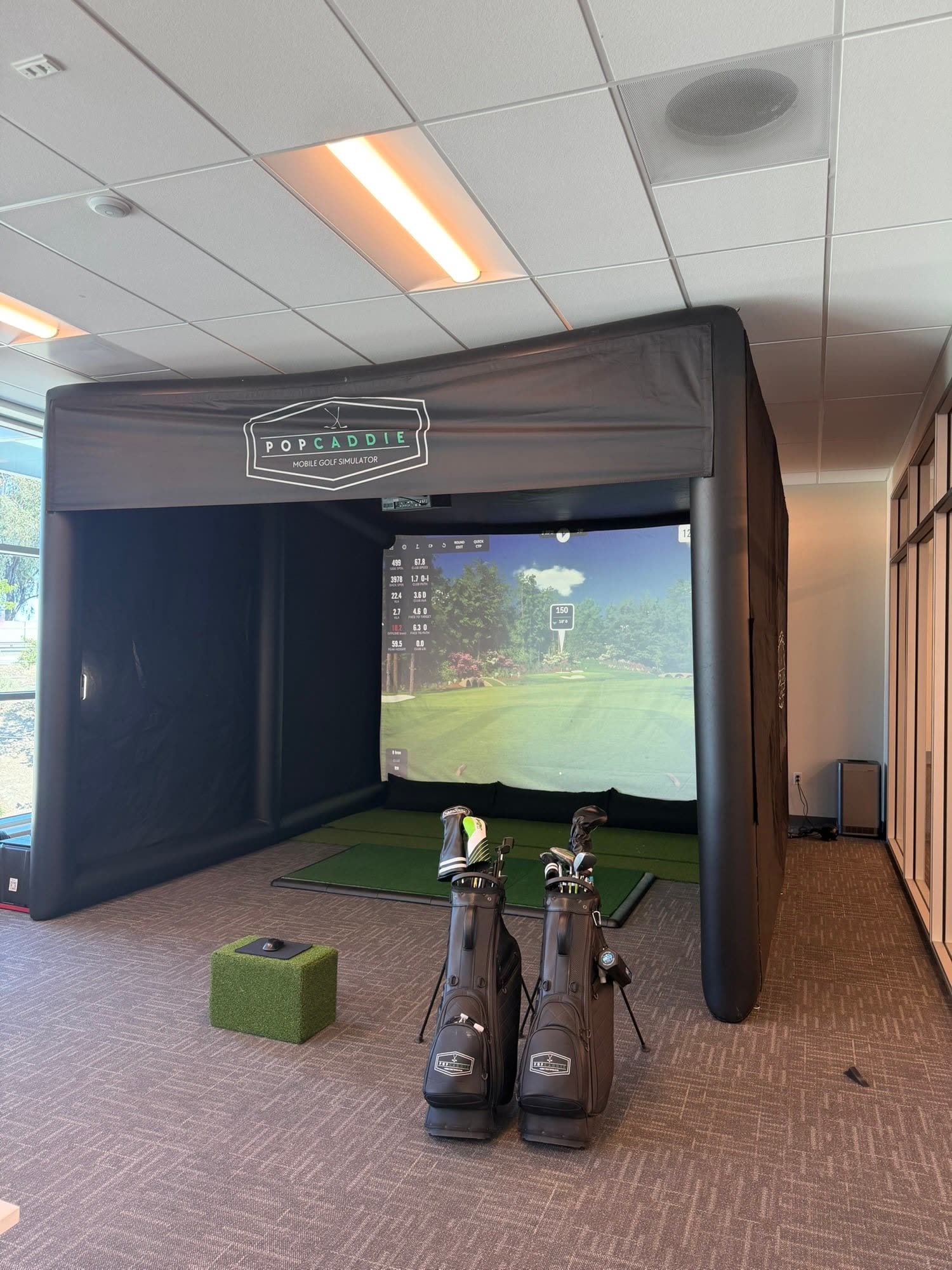 Golf simulator set up in an office (PopCaddie event)